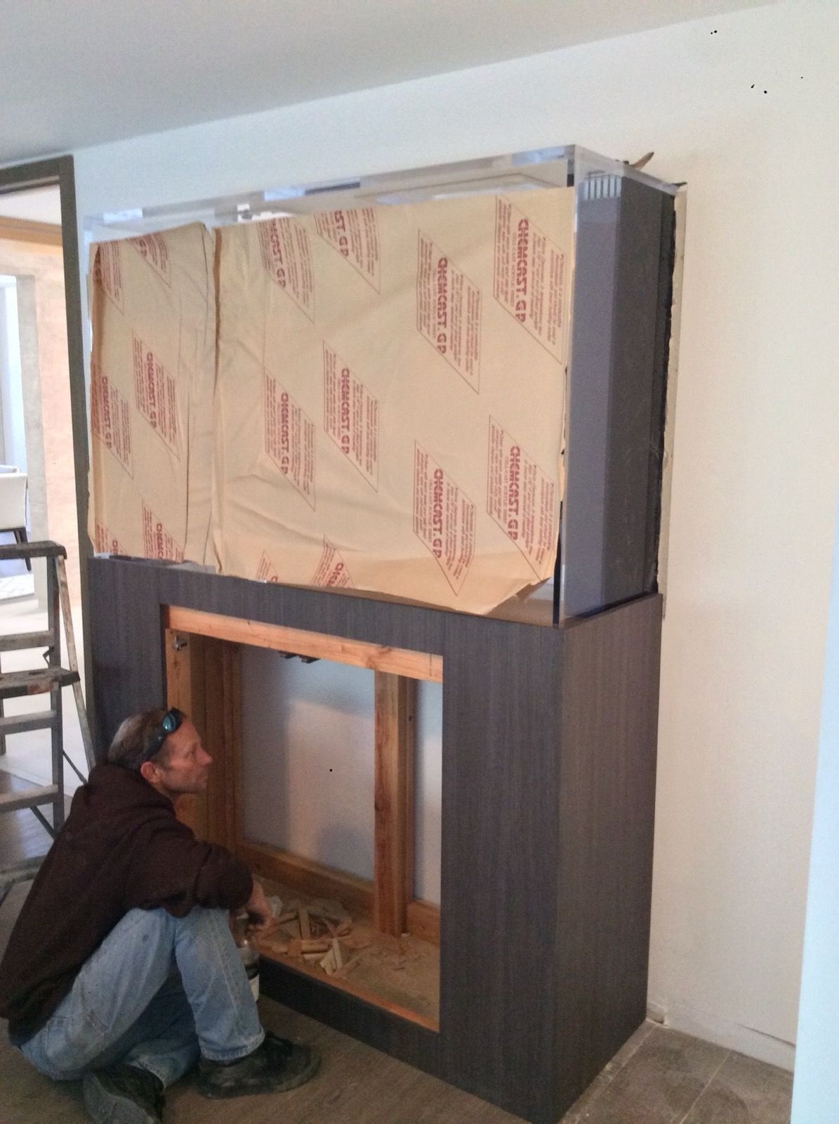 Nathan inspecting a custom aquarium stand during installation